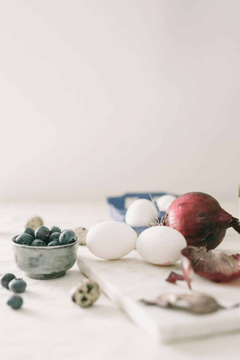 A tranquil still life of Easter eggs and ingredients on a kitchen table.